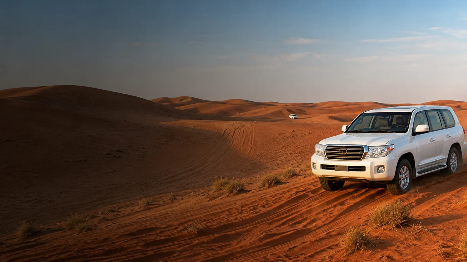 White four-wheel-drive desert Safari vehicle on the Lahbab red dunes in Dubai