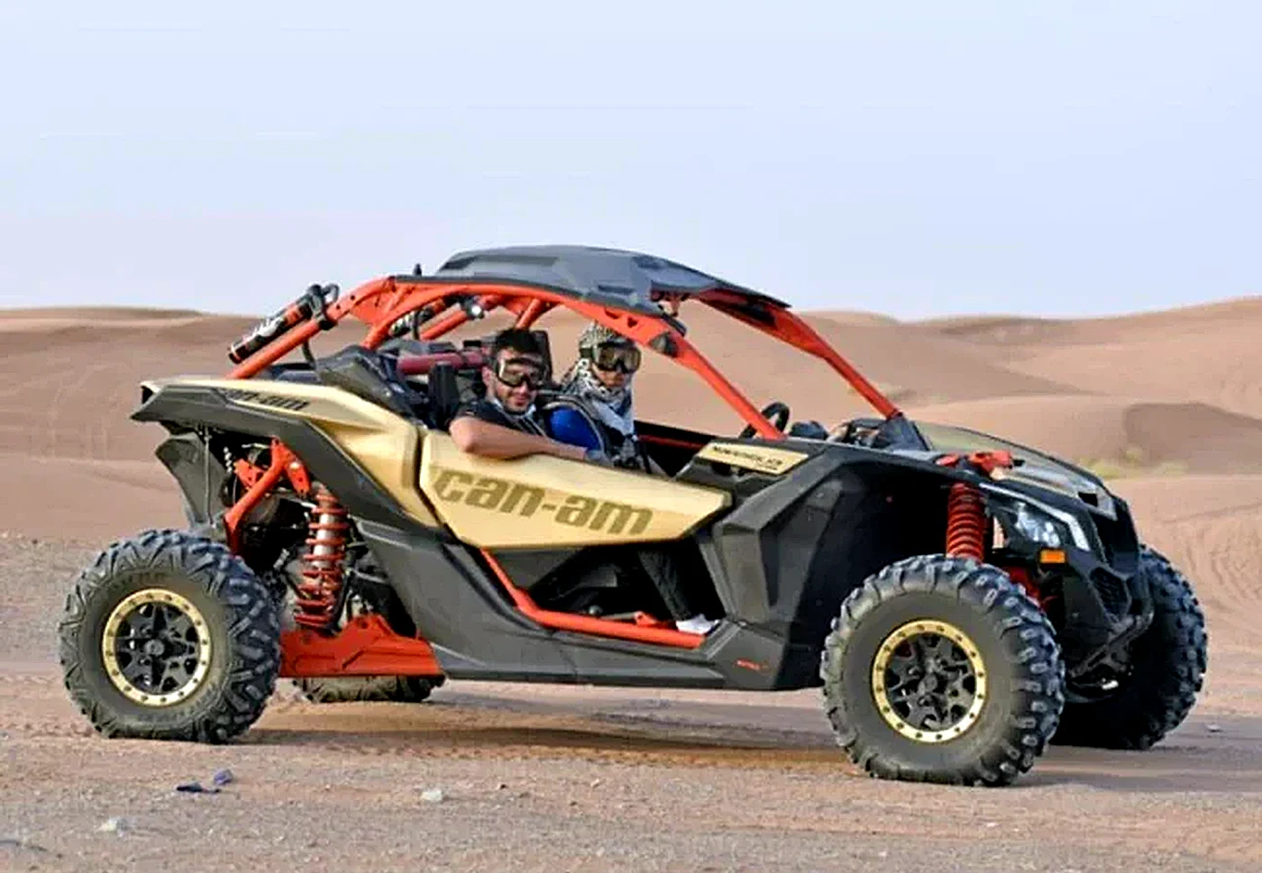 2 Seater Can-Am Maverick X3 dune buggy in Dubai red dunes - Desert Buggy Rental Dubai