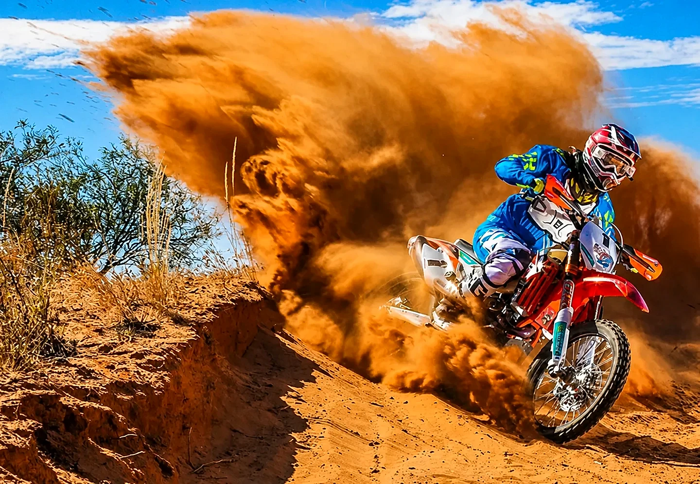 KTM dirt bike kicking up sand in the Dubai desert - Desert Buggy Rental Dubai