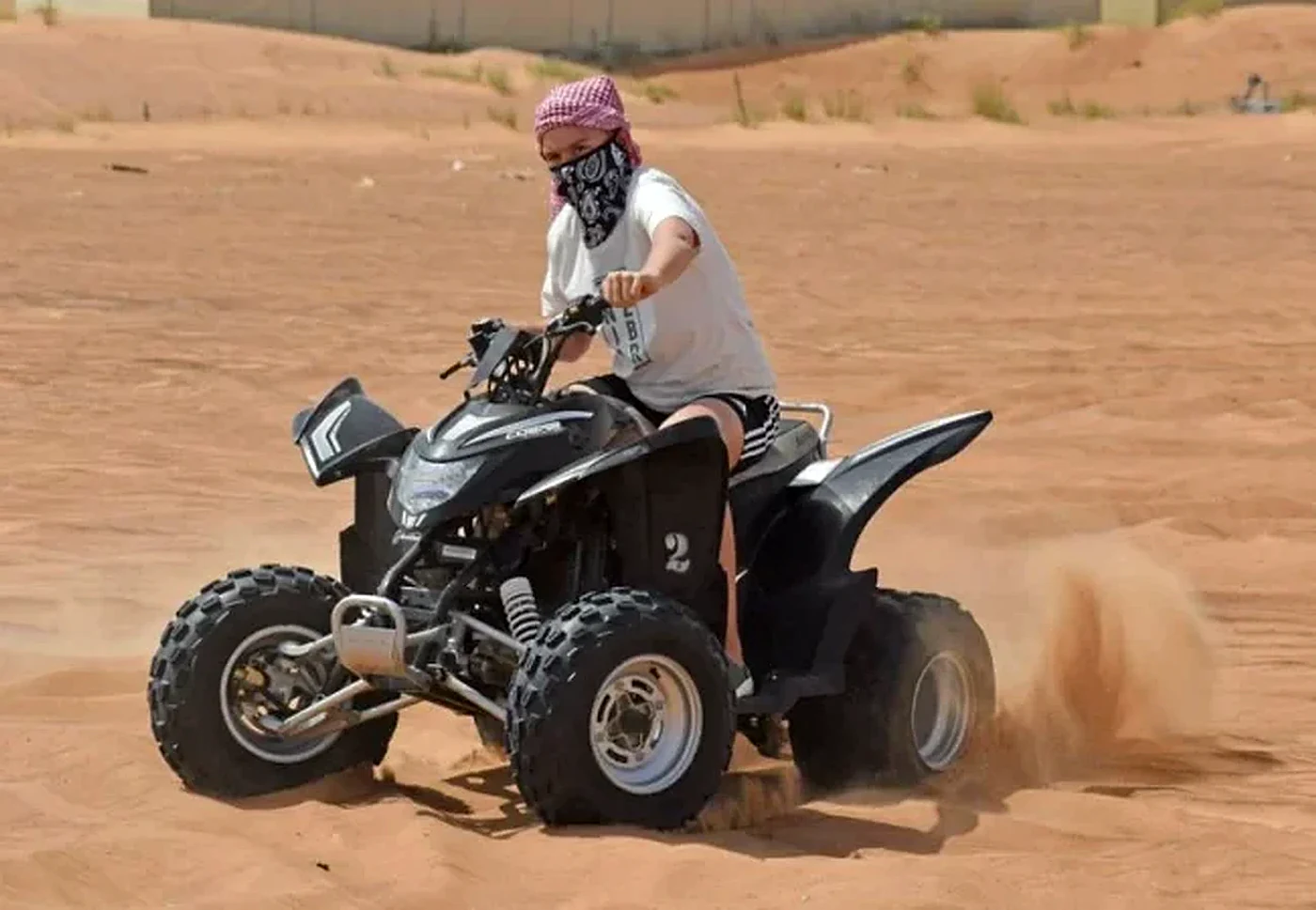 COBRA single seater quad bike on a fenced desert track in Dubai - Desert Buggy Rental Dubai