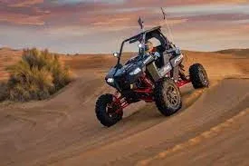 Tourists riding dune buggies across red Dubai desert dunes at sunset, kicking up sand in an exhilarating adventure