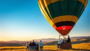 Green and yellow hot air balloon ride with passengers in the basket as a group watches over golden hills at sunrise