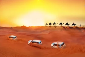 Tourists enjoying a thrilling dune bashing adventure in a 4x4 vehicle across the golden sand dunes of Dubai at sunset
