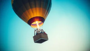 Passengers in a hot air balloon basket high in a clear sky as the burner flame heats the envelope
