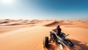 Tourists quad biking across the vast golden sand dunes of Oman's Wahiba Sands at sunset, with a clear sky