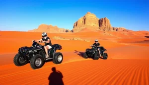 Tourists riding quad bikes across the red sands of Angola's Namib Desert at sunrise, kicking up dust