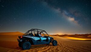 Tourists driving dune buggies across the dark Sharjah desert at night, with a clear sky full of stars above them