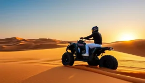 Tourists riding quad bikes across the vast Sahara Desert dunes in Merzouga, Morocco, with the sun setting