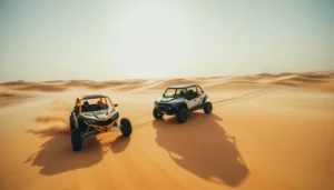 Dune buggy navigating through the rugged desert landscape of Ras Al Khaimah with mountains in the background, contrasting with smooth Dubai dunes.