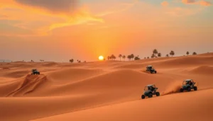 Several buggies crossing orange desert dunes at sunset with palm trees on a Dubai buggy safari tour
