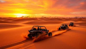 Three buggies racing across red sand dunes under a fiery sunset sky on a Dubai buggy tour