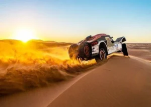 Tourists riding dune buggies across the vast desert terrain of Dubai, enjoying an exhilarating off-road adventure