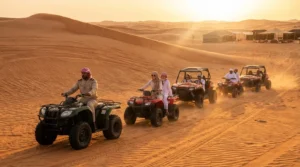 Tourists riding quad bikes across the gentle dunes of Al Marmoom desert in Abu Dhabi during a family-friendly tour