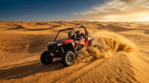 Self-drive dune buggy speeding across golden Dubai desert dunes at golden hour