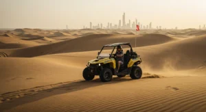 Rider on a self-drive quad bike crossing golden Dubai desert dunes at sunset