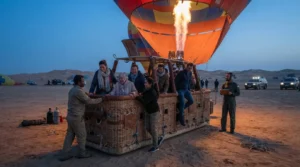 Passengers boarding compartments of a hot air balloon basket at dawn, where weight limits keep flights safe
