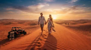 Couple walking on a Dubai red dune ridge at sunset during a desert shoot, with a dune buggy parked below