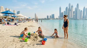 Children building a sandcastle and paddling in calm shallow water on a family-friendly Dubai beach