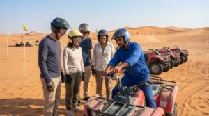 Instructor giving a quad bike safety briefing to helmeted riders before a quad bike rental Dubai tour