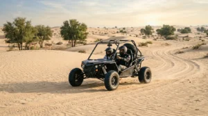 Self-drive dune buggy on a sandy track among ghaf trees during an Al Marmoom dune buggy safari in Dubai